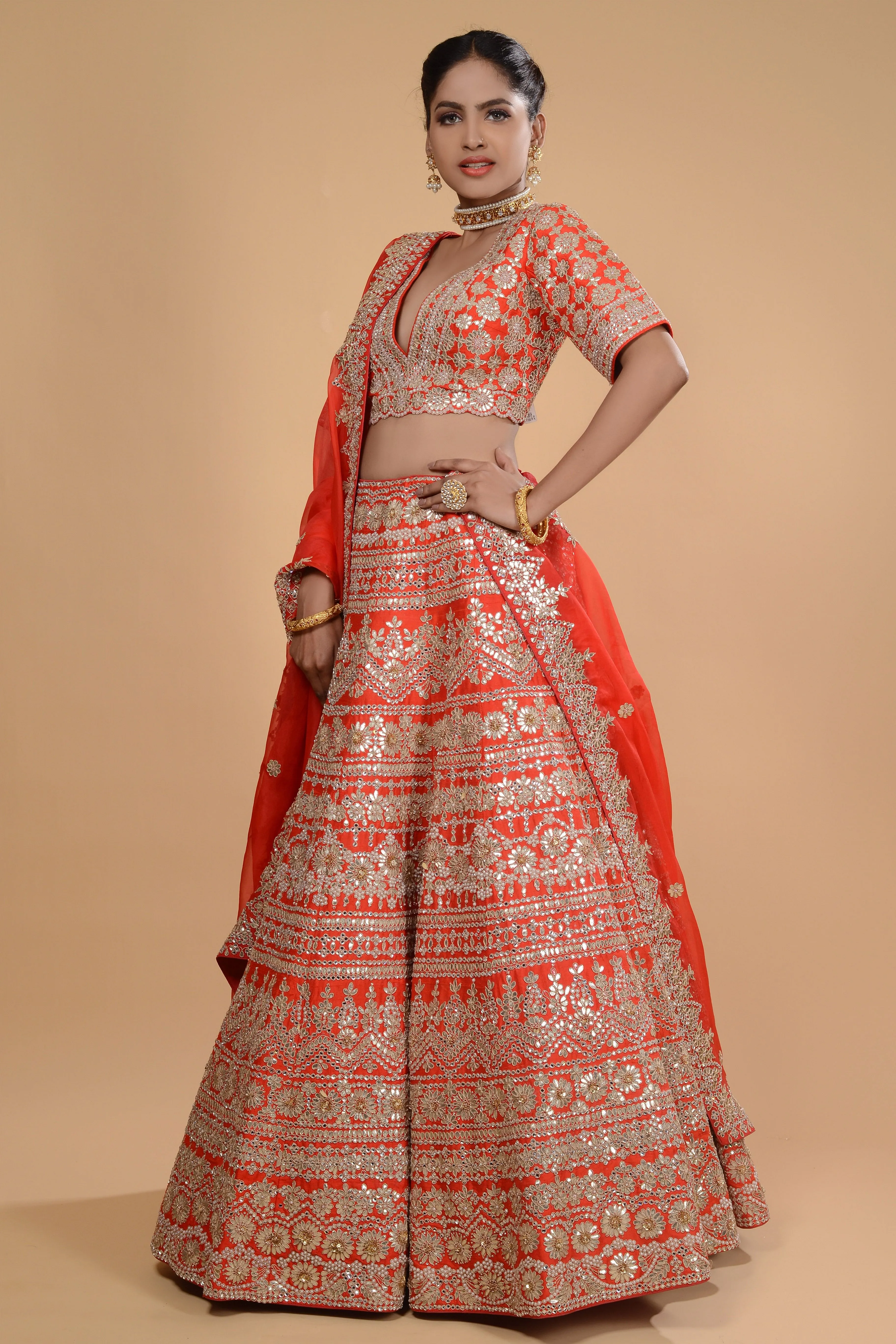 Bright Orange Embroidered Lehenga Set.