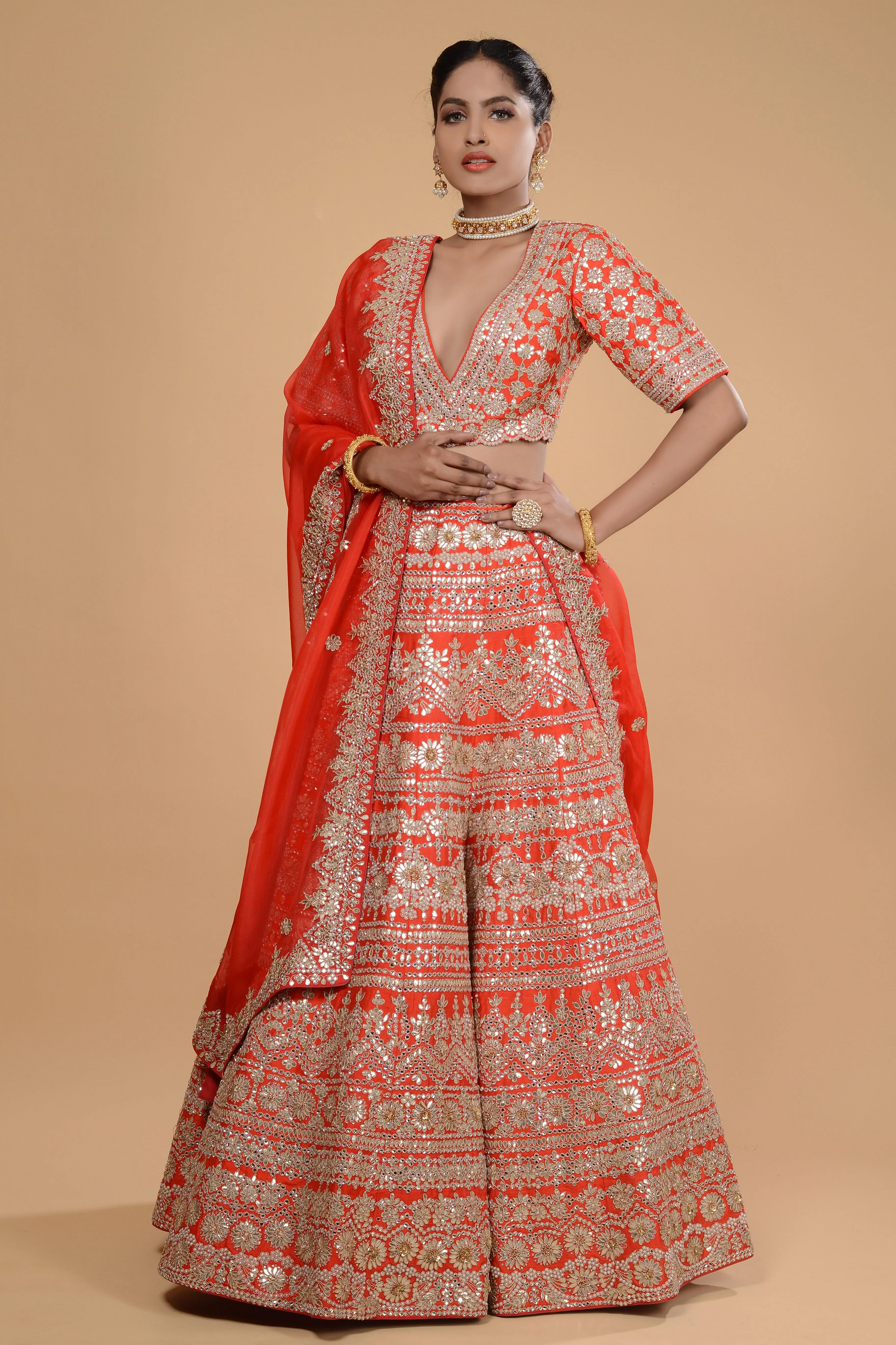 Bright Orange Embroidered Lehenga Set.