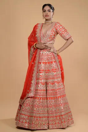 Bright Orange Embroidered Lehenga Set.