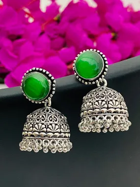 Elegant Emerald Stone Studded Silver Toned Oxidized Jhumka Earrings With Black Pearl Beads